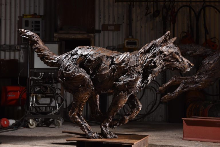 Sculpture of wolf running
