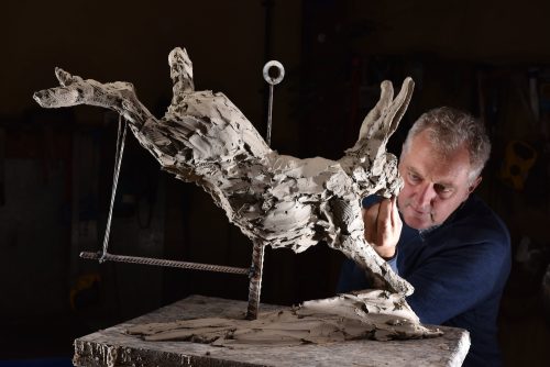 Mackie in studio with Hare Running sculpture
