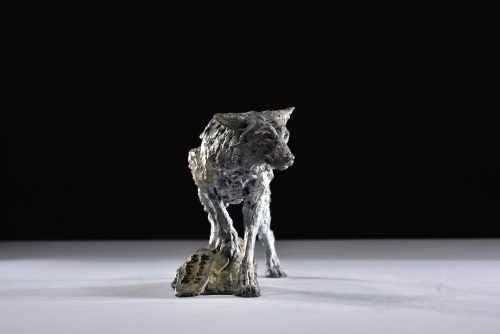 sculpture of wolf on a mound