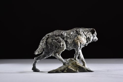wolf on a mound sculpture