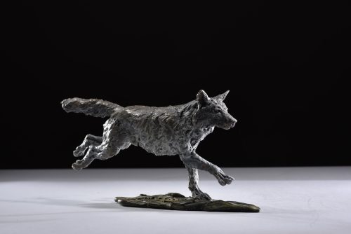 running legs out wolf sculpture