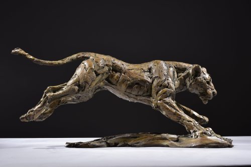 sculpture of lioness hunting