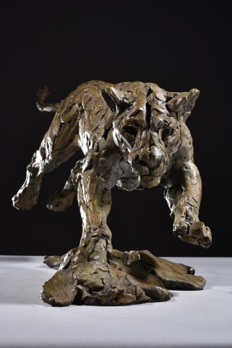 Bronze sculpture of lioness hunting