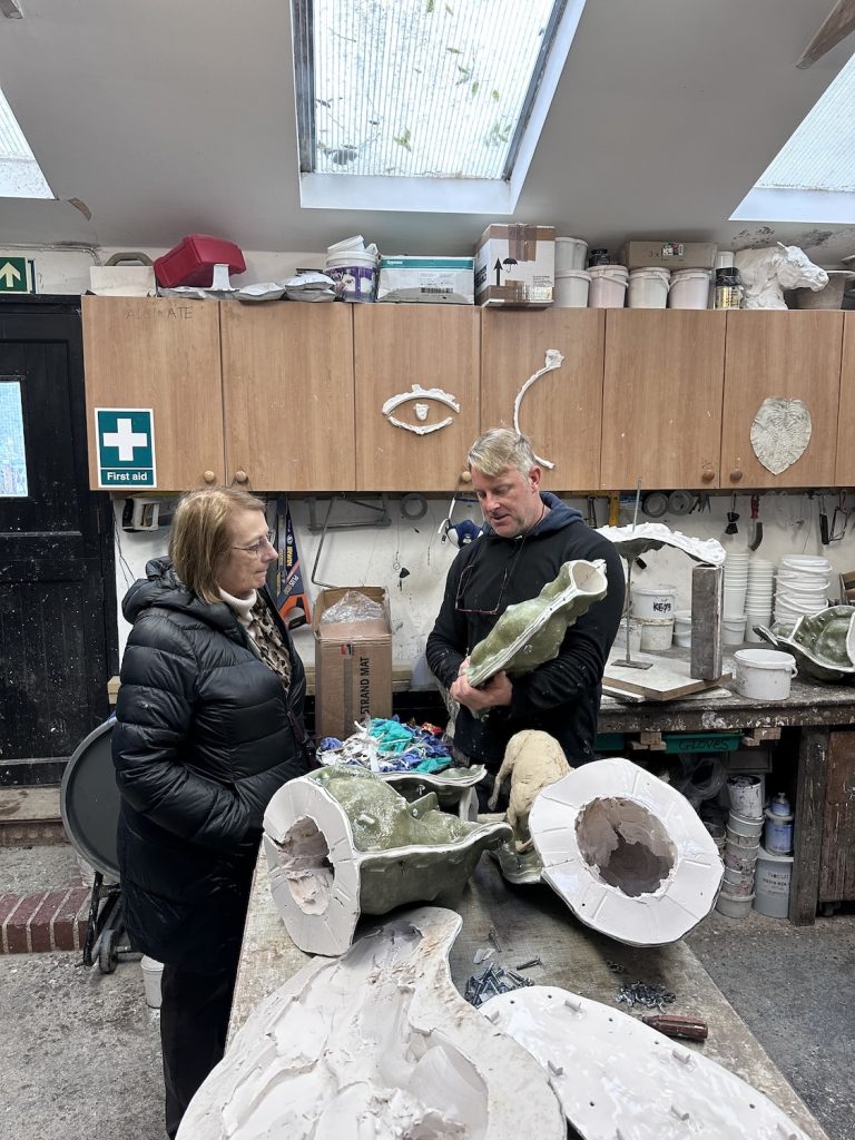 Nina Campbell at foundry with man showing moulds.