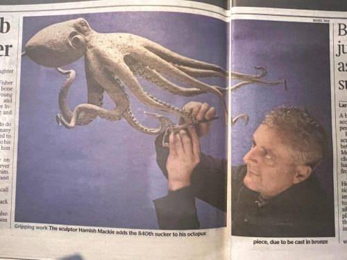 Mackie with Octopus sculpture in Times newspaper