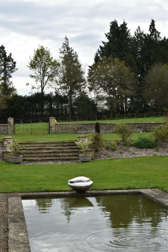 cowrie shell sculpture by pond