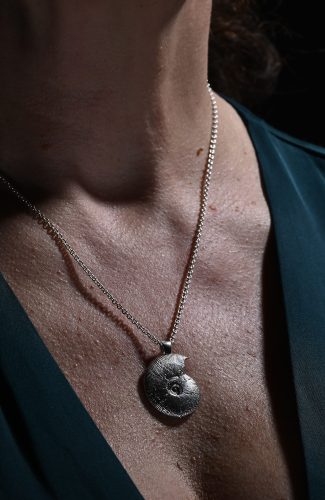 model wearing silver ammonite pendant