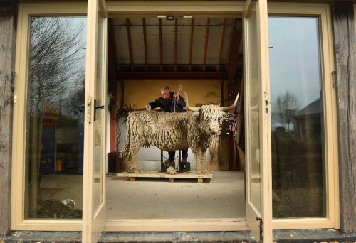 Hamish sculpting highland cow in his studio