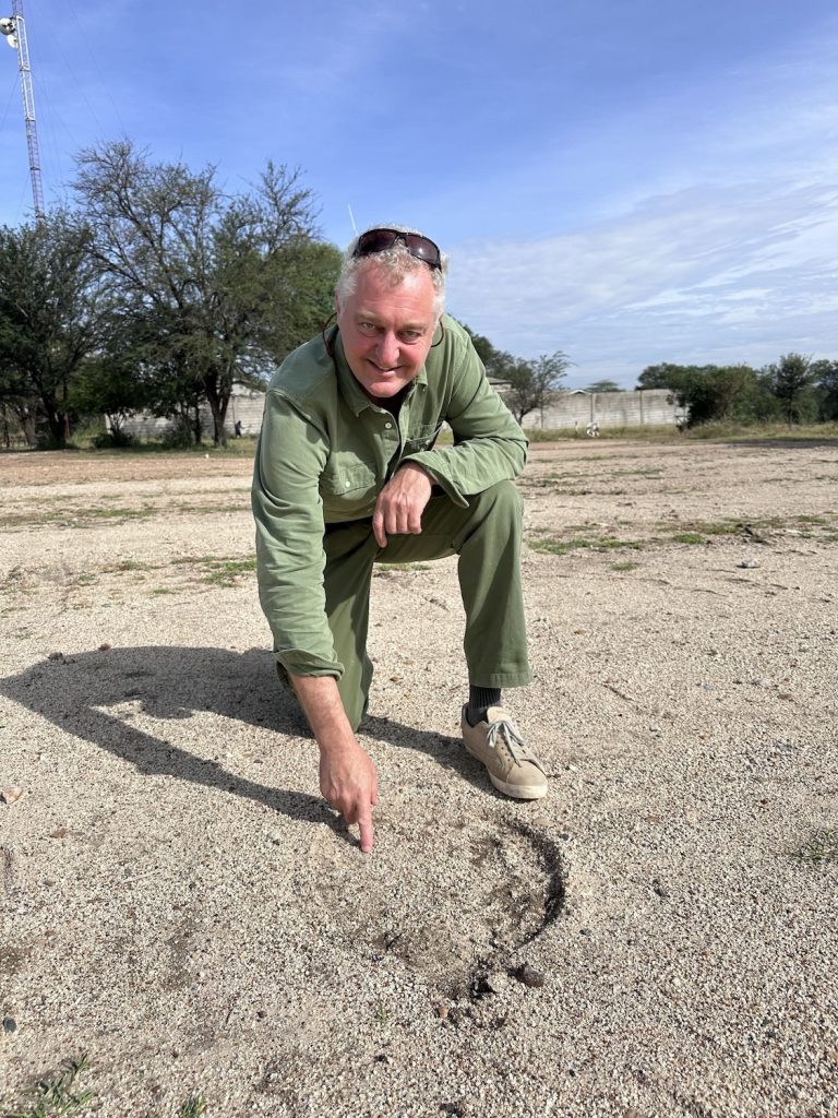 Hamish with elephant footprint