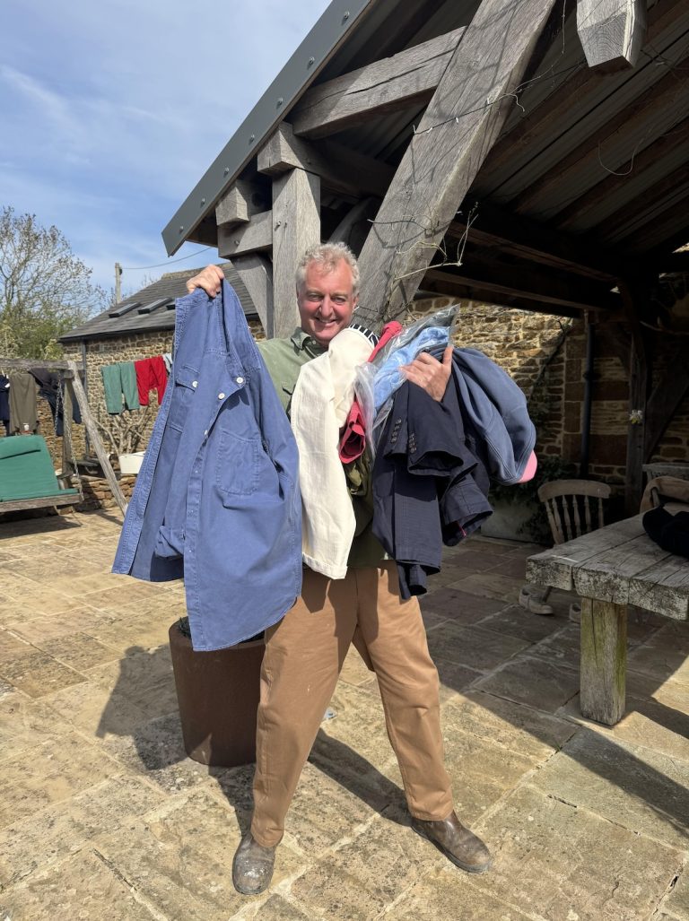 Hamish with armful of clothes