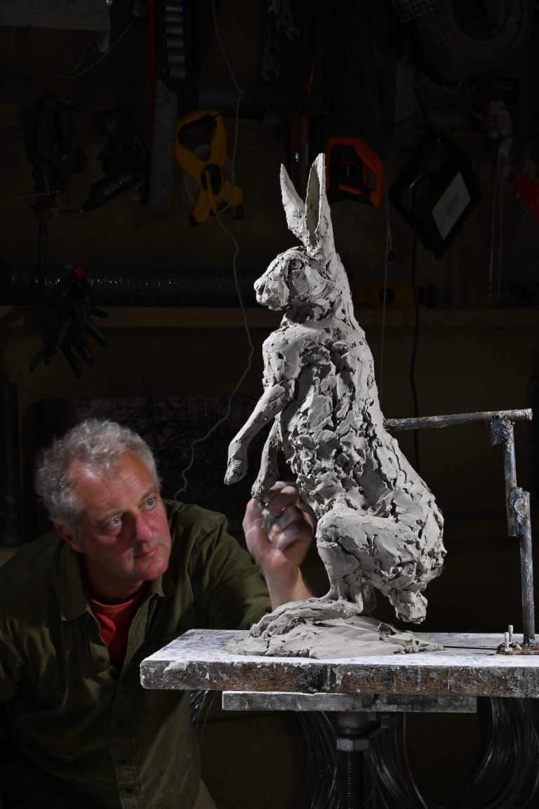 Hamish making hare standing sculpture