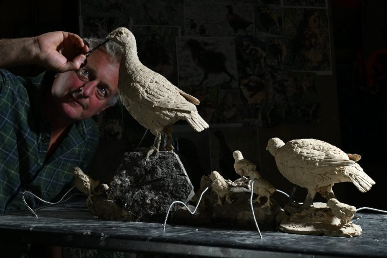 Mackie making grouse sculpture